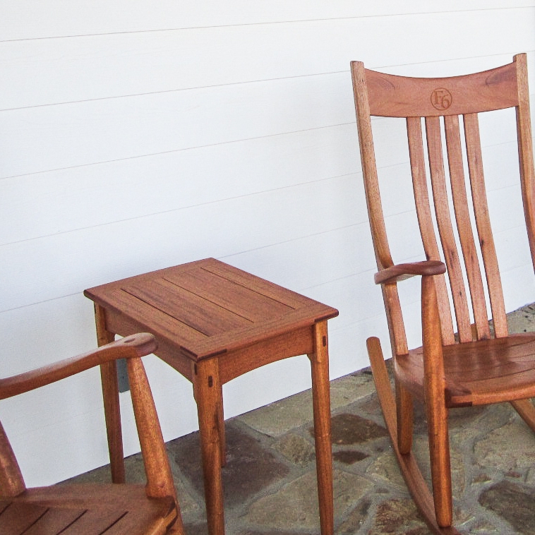 mahogany side table and rocker on porch