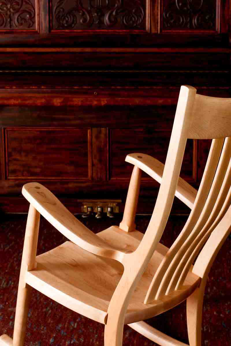 maple rocking chair by the piano